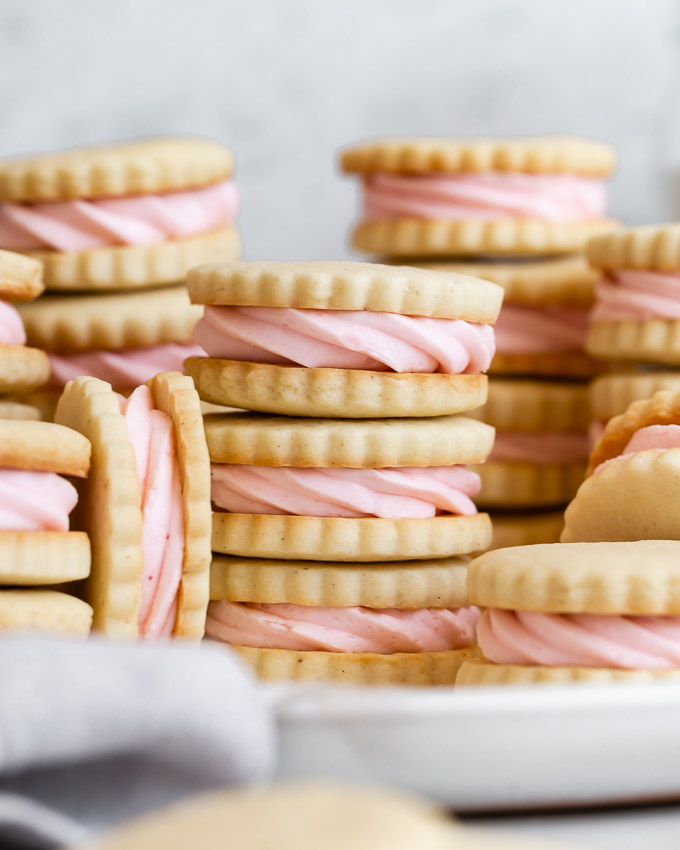 close-up of vanilla bean shortbread cookies with strawberry buttercream
